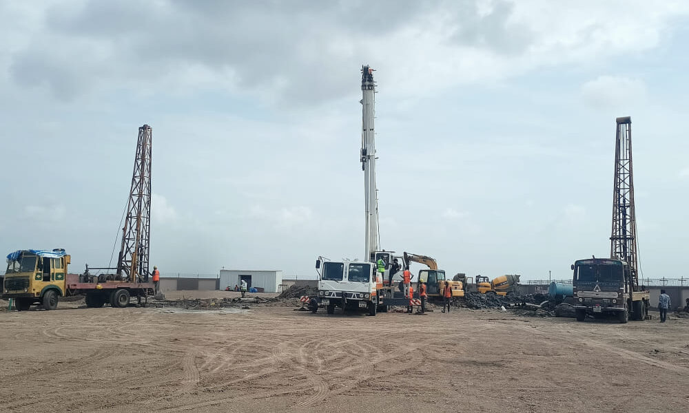 Rotary foundation piling work at a construction project in Dholera, Gujarat using advanced piling equipment for deep foundation installation.