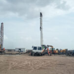 Rotary foundation piling work at a construction project in Dholera, Gujarat using advanced piling equipment for deep foundation installation.